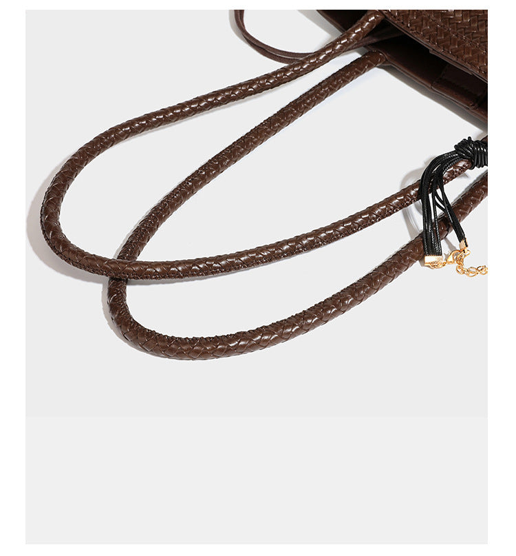 Structured woven leather-look tote bag in dark brown with long shoulder straps, side drawstring ties, and gold filigree