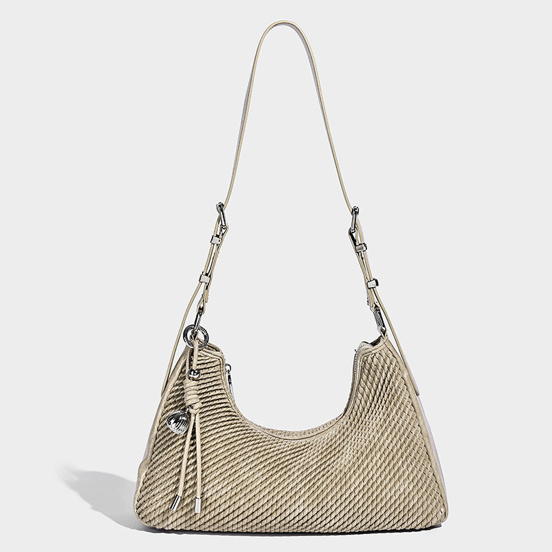 Woven crescent hobo shoulder bag with smooth side panels, zip-top closure, silver-tone charm hardware, and adjustable, detail
