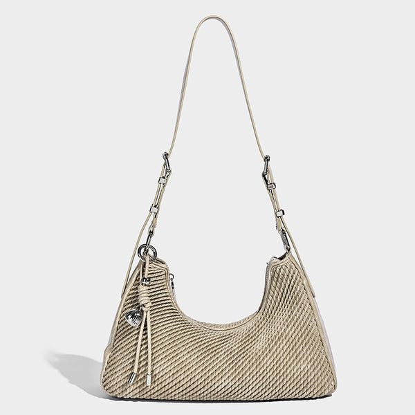 Woven crescent hobo shoulder bag with smooth side panels, zip-top closure, silver-tone charm hardware, and adjustable, detail