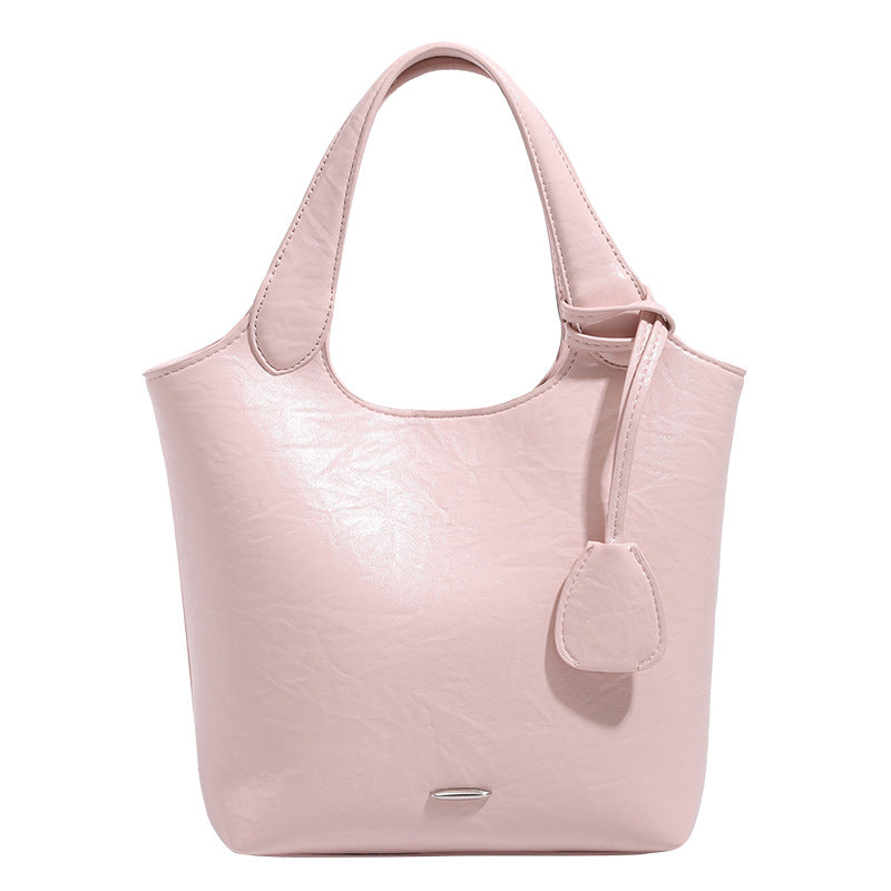 Soft glossy leather-look bucket tote bag with twin handles and detachable crossbody strap, detail view 5