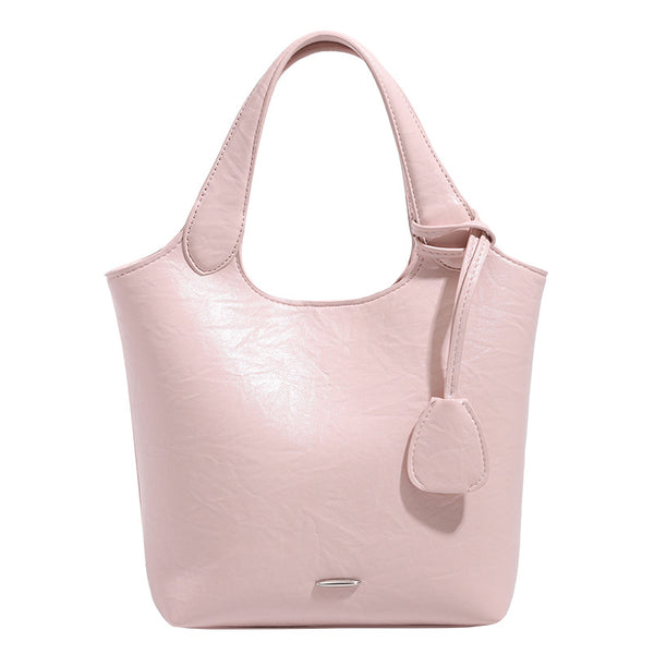Soft glossy leather-look bucket tote bag with twin handles and detachable crossbody strap, detail view 5