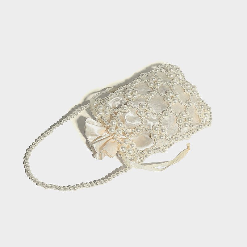 Small pearl-beaded lattice drawstring bucket bag with beaded shoulder strap and ribbon closure, detail view 20