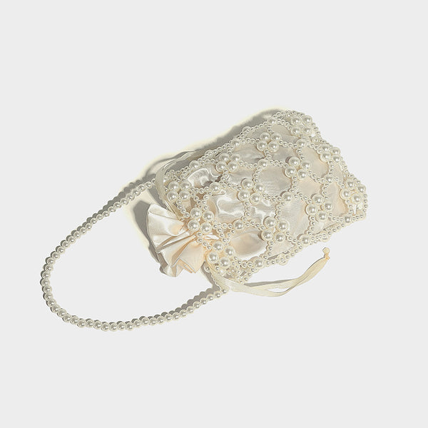 Small pearl-beaded lattice drawstring bucket bag with beaded shoulder strap and ribbon closure, detail view 20
