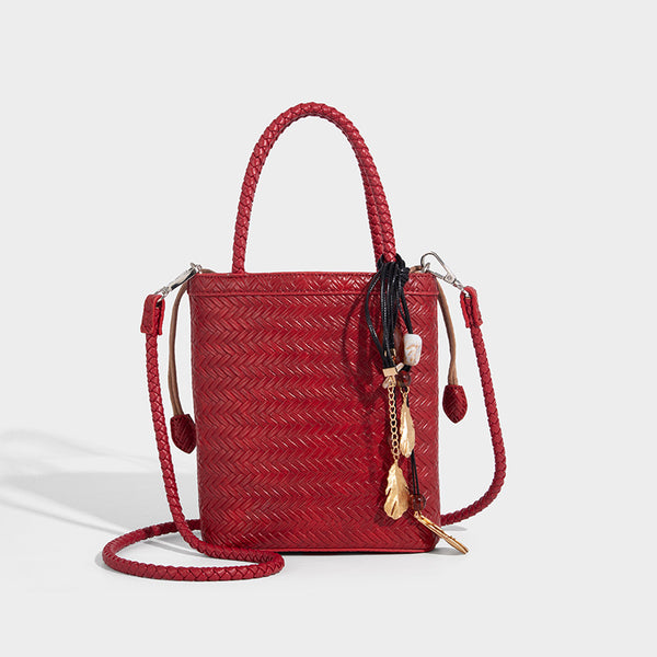 Small structured woven-texture tote bag with braided top handles and drawstring inner pouch, detail view 9