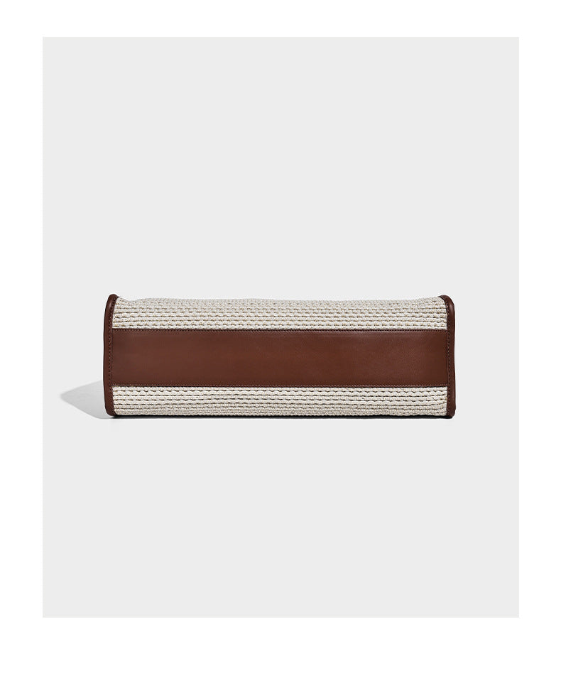 Two-tone woven straw tote bag with leather-look brown trim, long shoulder straps, and knotted tassel charm, detail view 13