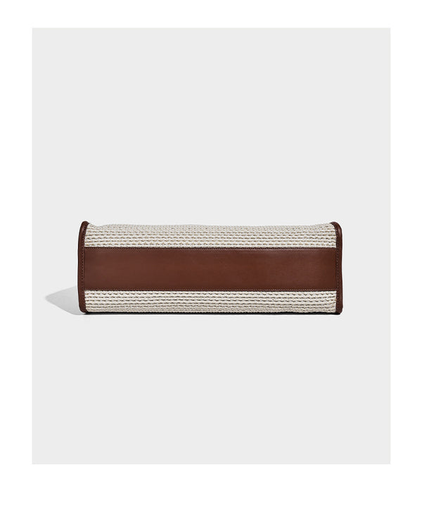 Two-tone woven straw tote bag with leather-look brown trim, long shoulder straps, and knotted tassel charm, detail view 13