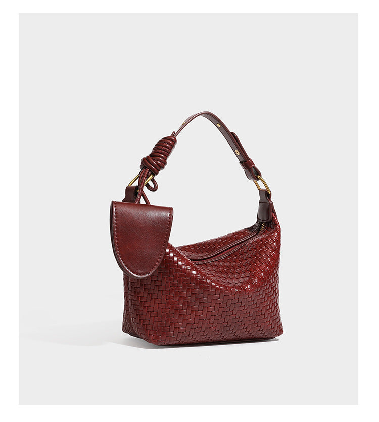 Small glossy basket-weave hobo shoulder bag in brown with knotted top handle, flap accent pocket, and gold-tone hardware
