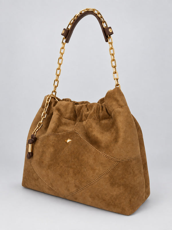 Slouchy suede-look shoulder bag with gathered top, angular stitched paneling, and chunky gold-tone chain strap, detail view
