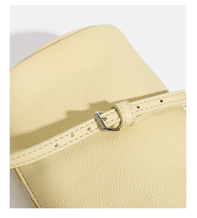 Kompakte Schultertasche in genarbter Lederoptik mit Reißverschluss oben, geknotetem Tragegriff und verstellbarem Crossbody-Riemen, Detailansicht