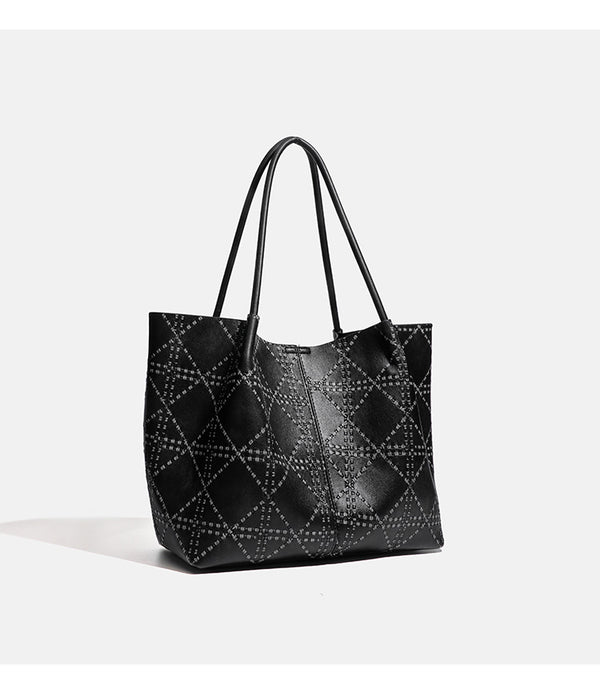 Large open-top tote bag with raised diamond-lattice stitching, long double shoulder handles, and gold-tone magnetic snap