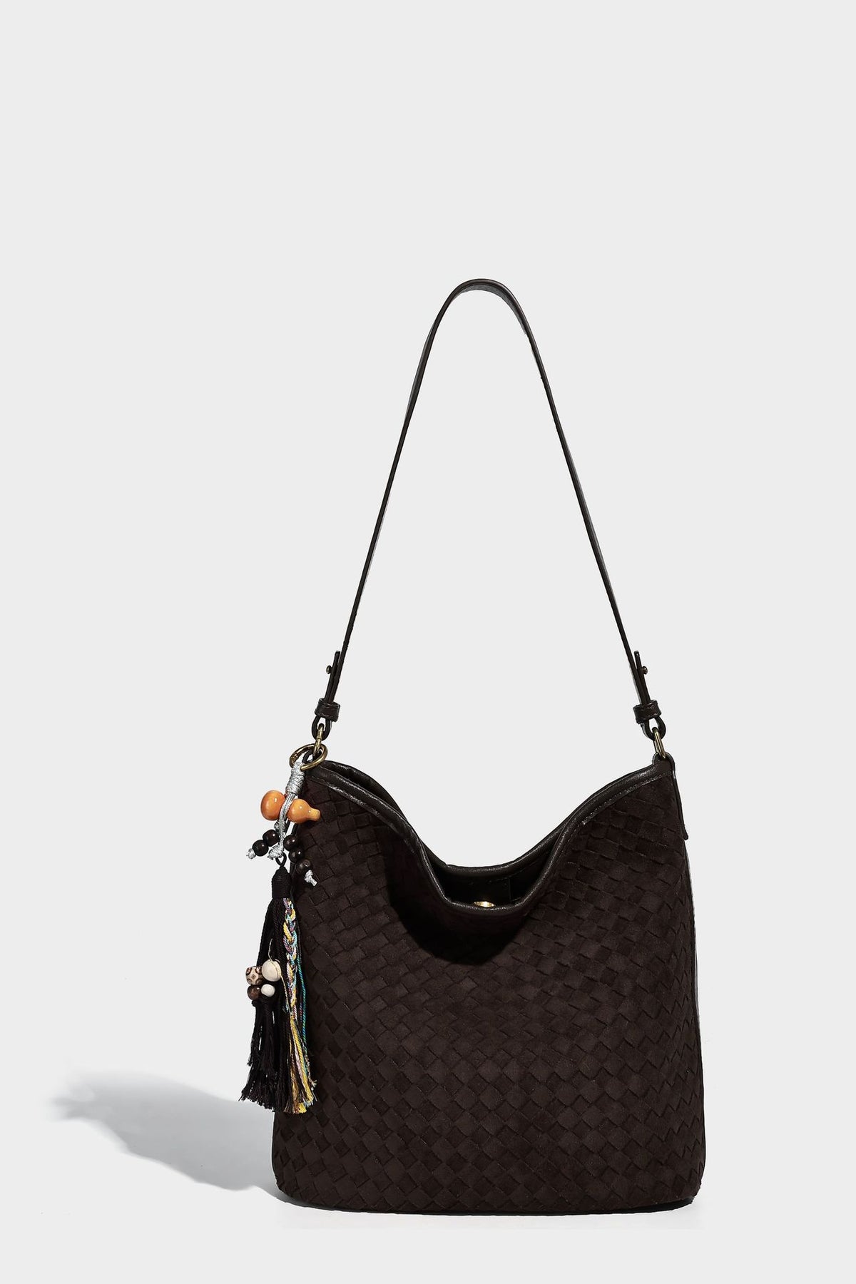 Dark chocolate woven texture hobo shoulder bag with multicolor tassel-and-bead charm and long adjustable strap, detail view