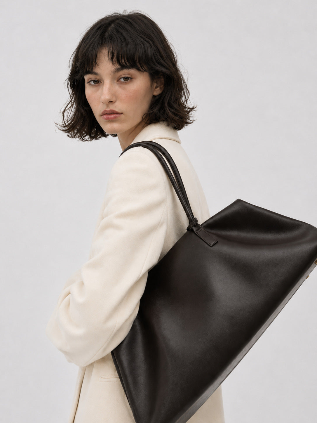 Large structured black Boston tote bag with double shoulder handles and full-length front zipper compartment, detail view 13