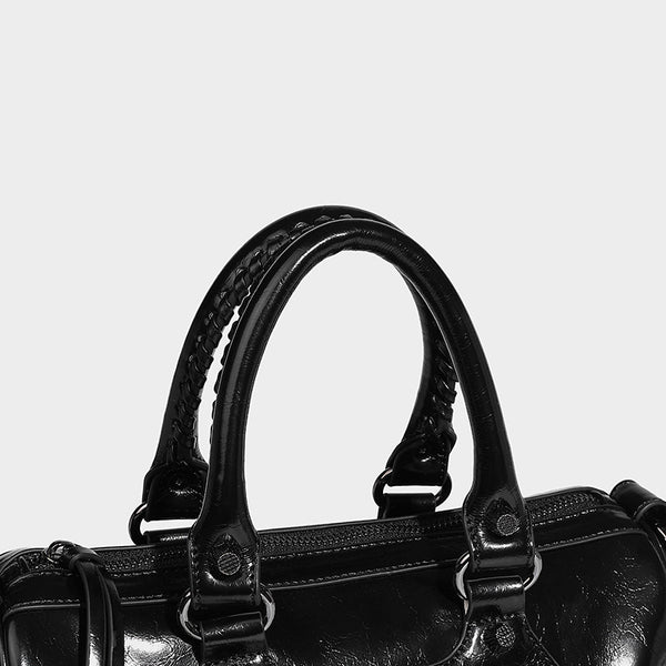 Glossy studded mini satchel bag with braided top handles, front zip pocket, heart charm, and detachable crossbody strap