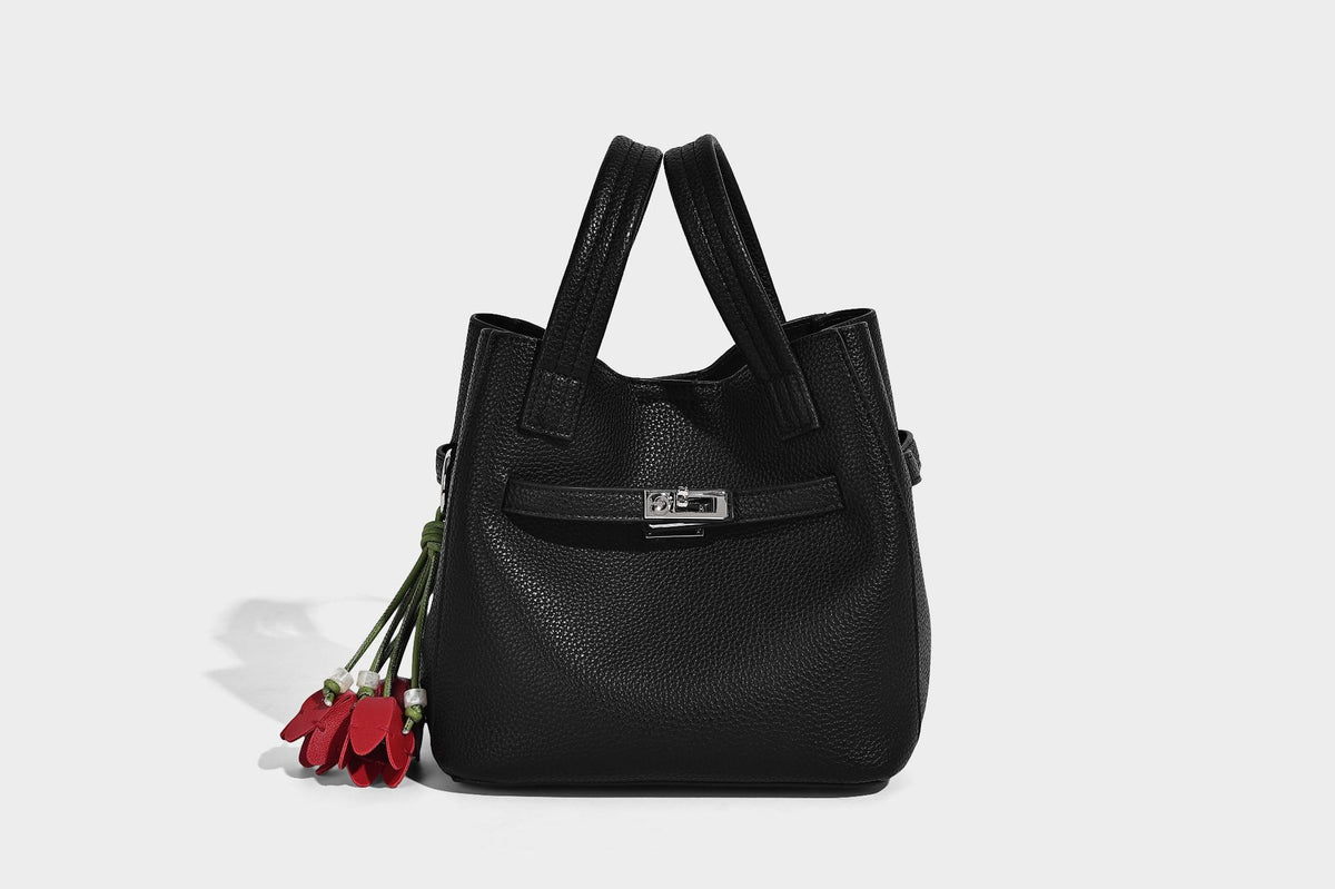 Small structured pebbled bucket tote bag with dual top handles, silver turn-lock front pocket, and detachable shoulder strap