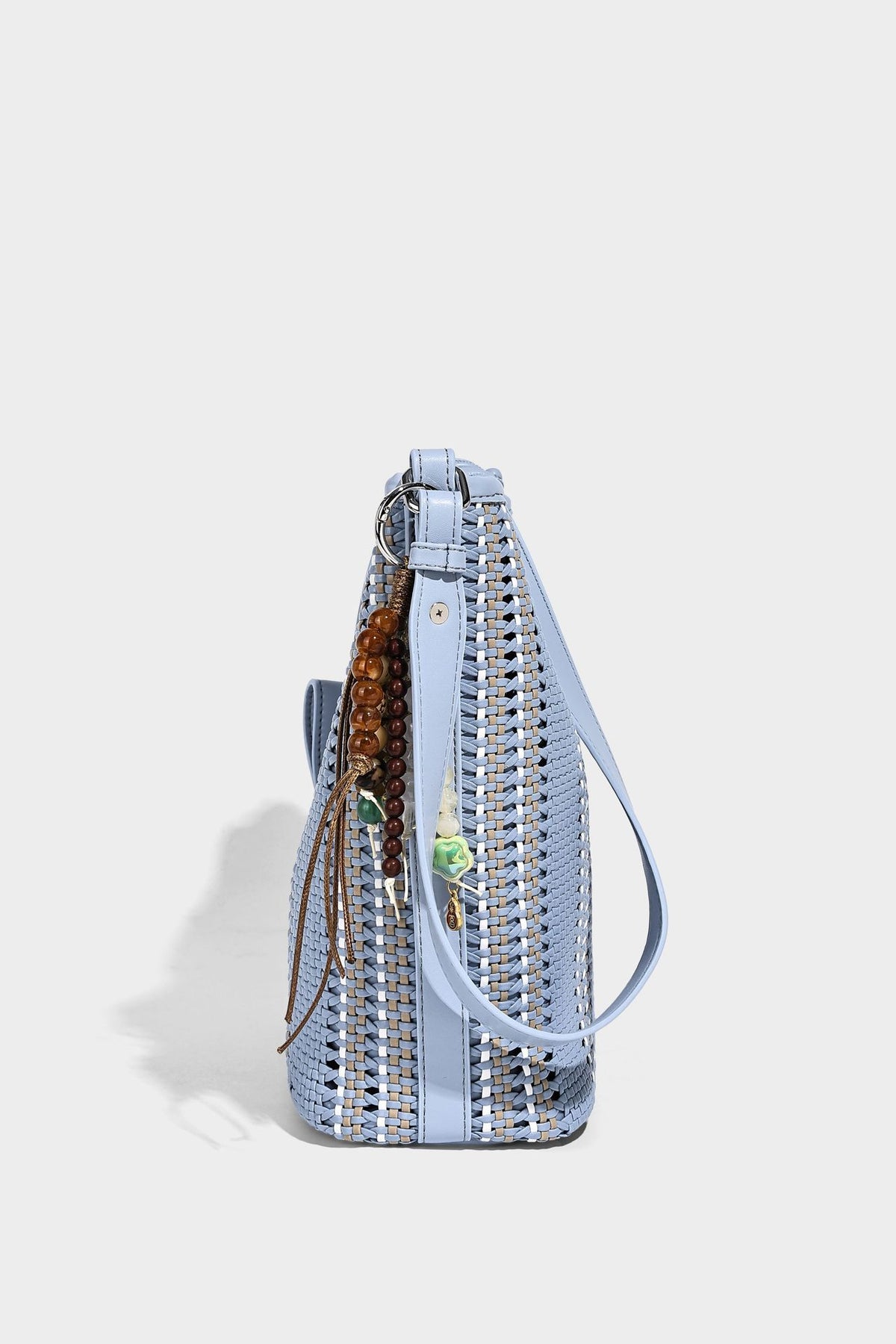 Woven bucket shoulder bag with leather-look trim, silver-tone hardware, and beaded tassel charm, detail view 32