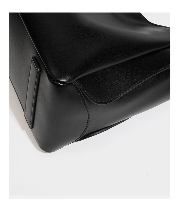 Structured glossy leather-look tote shoulder bag with dual top handles, detachable crossbody strap, side pockets, and, detail