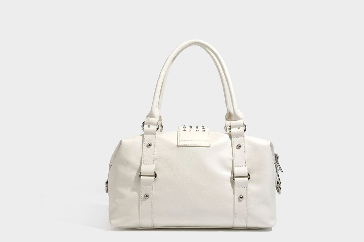Glossy crinkled barrel handbag with silver stud buckle strap and detachable shoulder strap, detail view 22