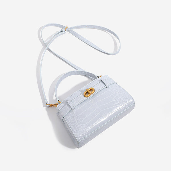 Small structured crocodile-embossed top-handle bag with gold-tone turn-lock closure and detachable shoulder strap, detail