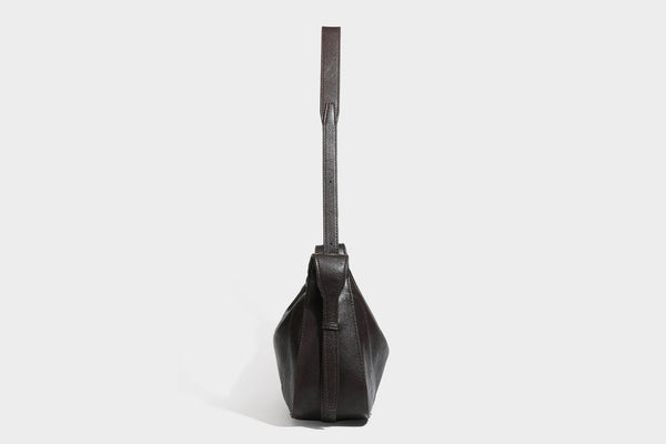 Slouchy crescent hobo shoulder bag in dark brown pebbled leather-look finish with zip top and long shoulder strap, detail