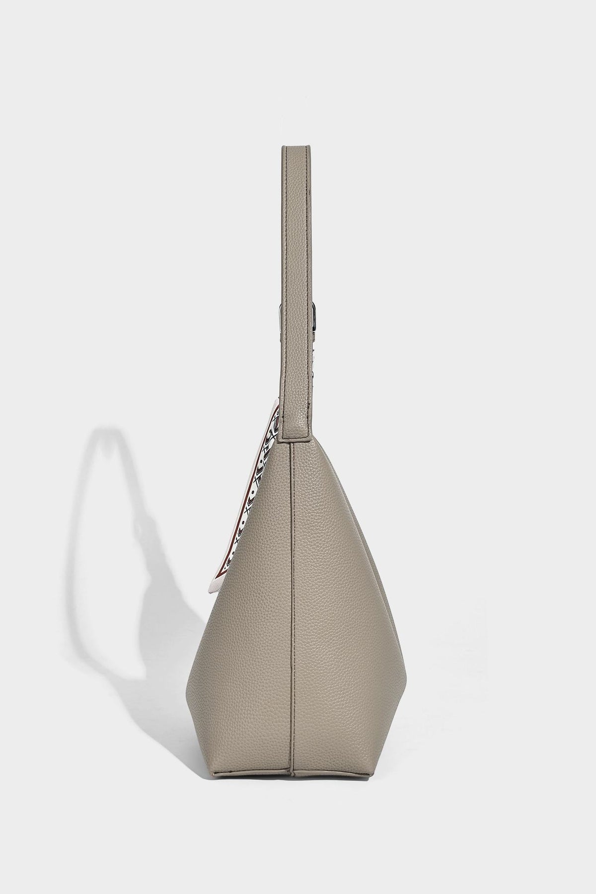 Soft slouchy hobo shoulder bag in pebbled matte finish with slim strap, silver-tone ring hardware, and knotted printed scarf
