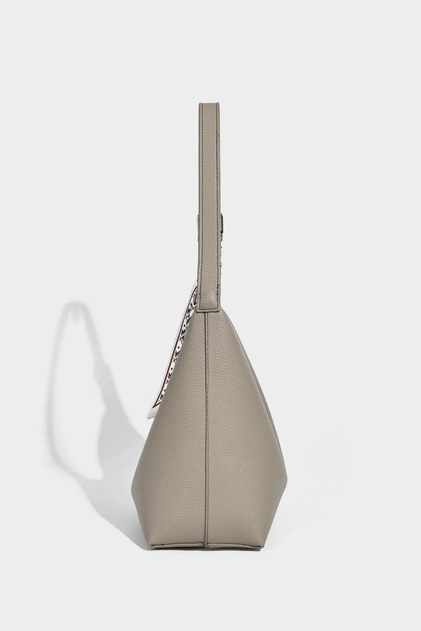 Soft slouchy hobo shoulder bag in pebbled matte finish with slim strap, silver-tone ring hardware, and knotted printed scarf