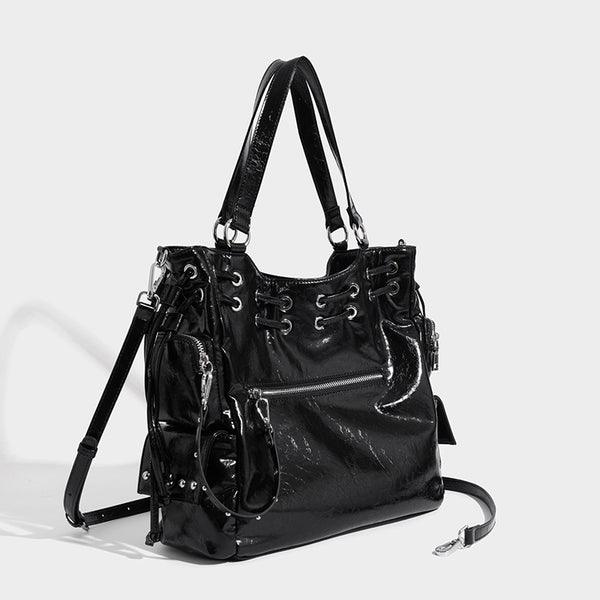 Glossy crinkled leather-look tote bag with silver grommet lace-up front detail, dual top handles, and detachable shoulder