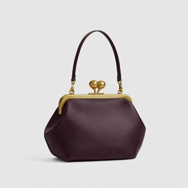 Oversized kiss-lock frame handbag with gold-tone metal clasp and smooth leather-look finish, detail view 13