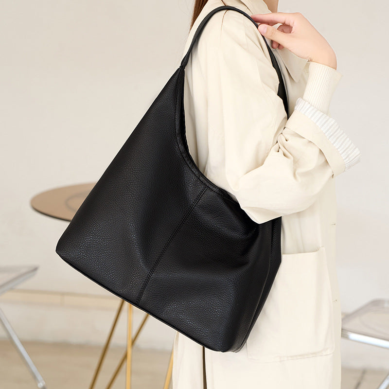 Large slouchy hobo shoulder bag in pebbled matte leather-look finish with single flat strap, detail view 3