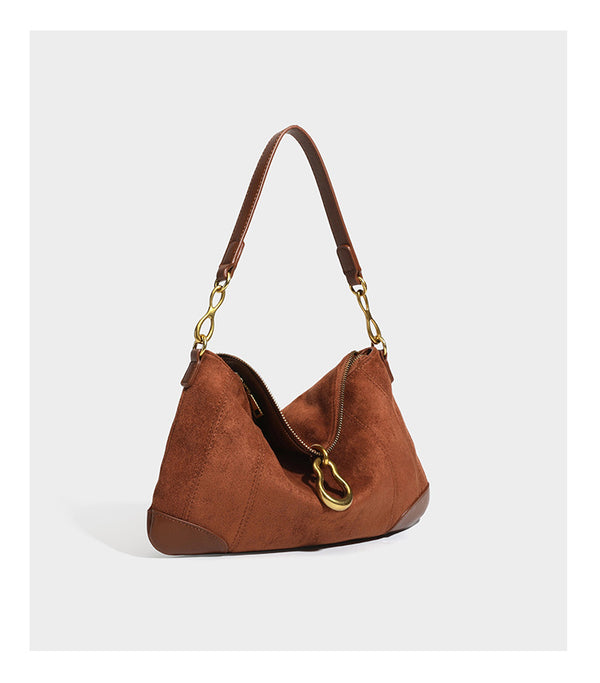 Slouchy denim shoulder bag with dark leather-look trim, gold-tone chain-link hardware, and top zipper closure, detail view 16