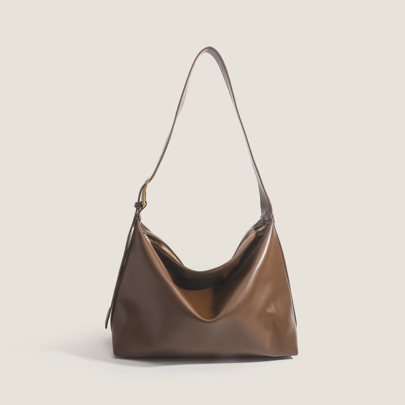 Large slouchy hobo shoulder bag in smooth leather-look finish with single long strap and gold-tone zip closure, detail view 8