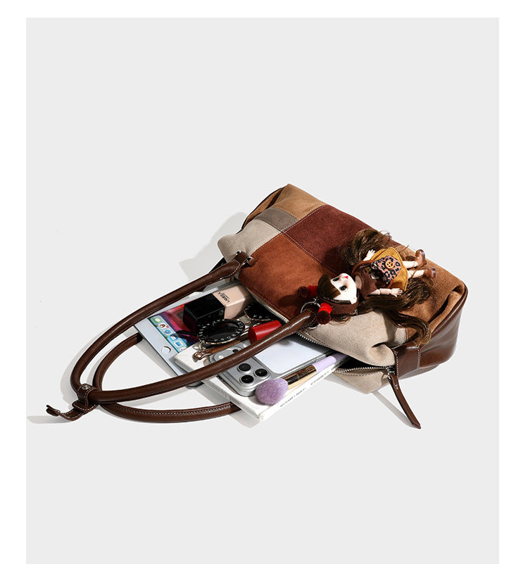 Patchwork suede-look barrel shoulder bag in brown, rust, tan, beige, and gray panels with double leather-look straps and