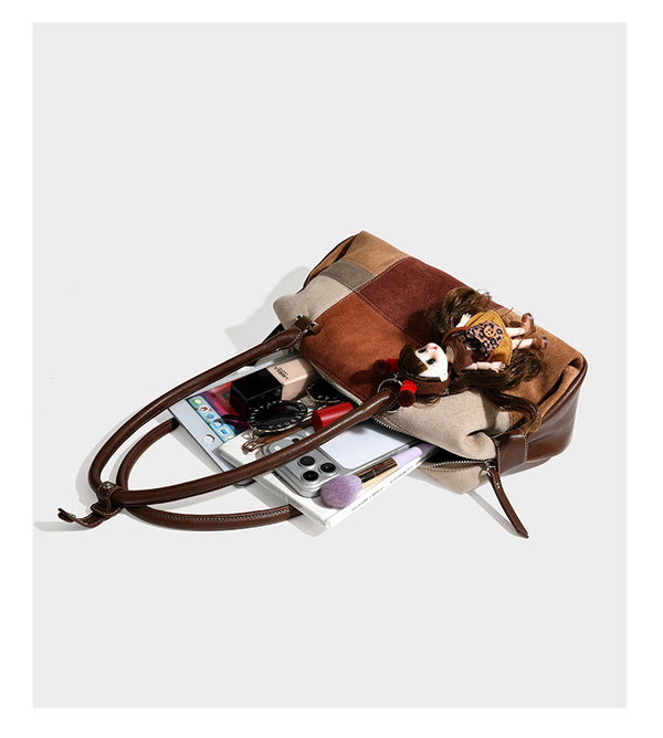 Patchwork suede-look barrel shoulder bag in brown, rust, tan, beige, and gray panels with double leather-look straps and
