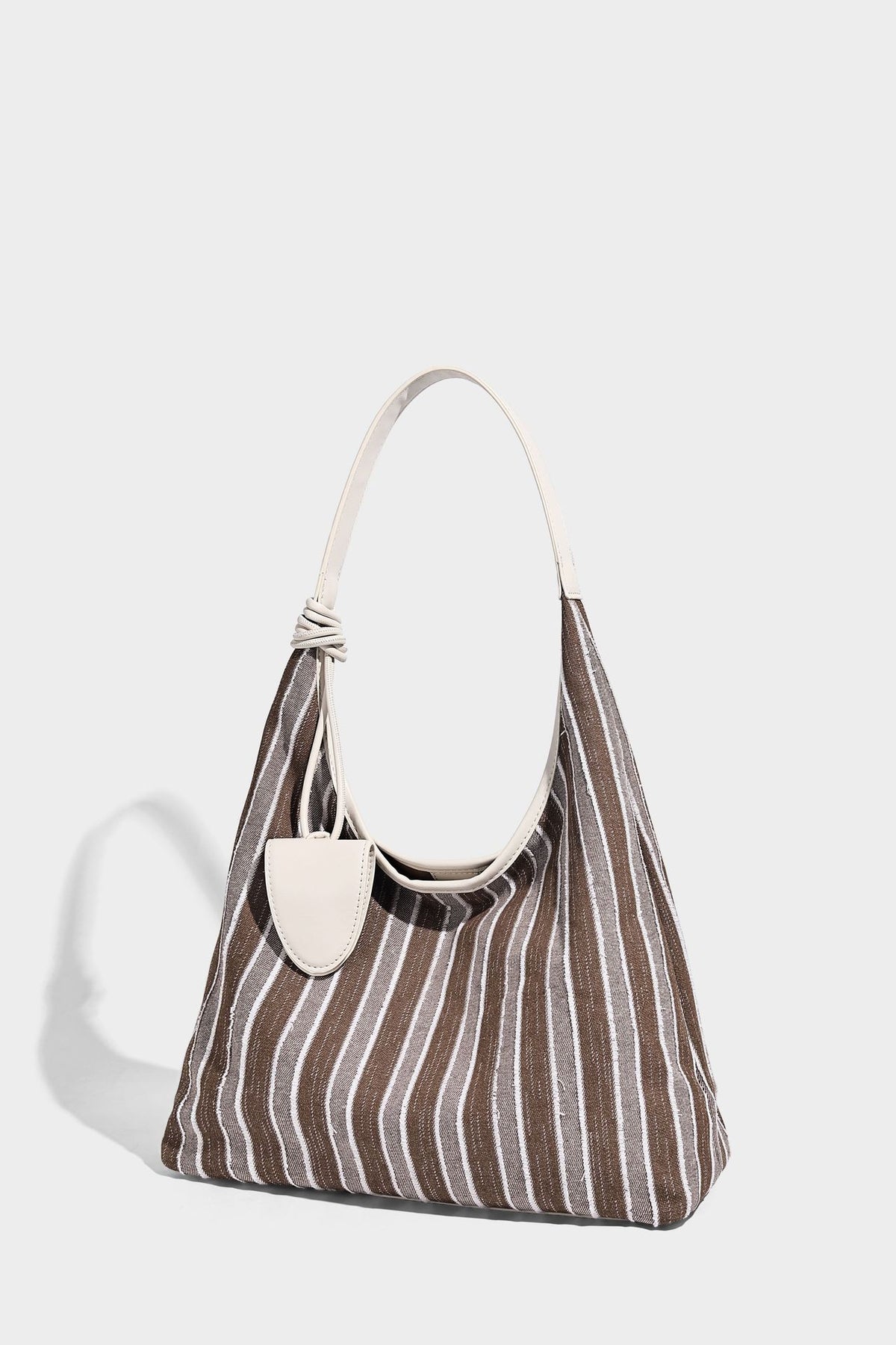 Slouchy striped canvas hobo shoulder bag with cream trim and long knotted strap, detail view 9