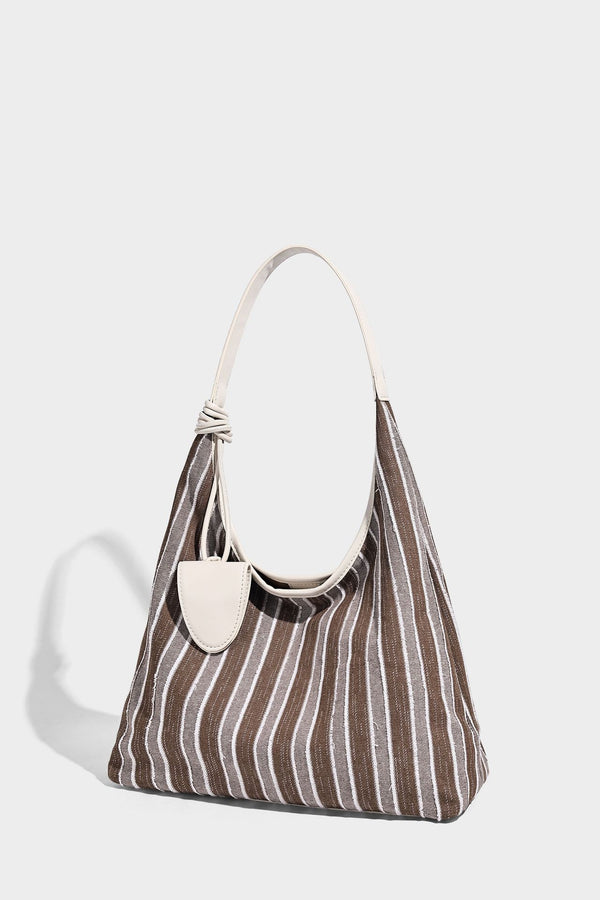 Slouchy striped canvas hobo shoulder bag with cream trim and long knotted strap, detail view 9