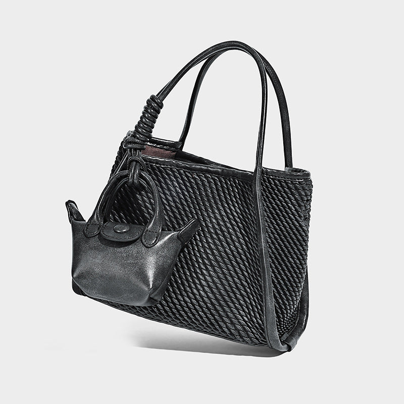 Large structured woven rope-texture tote bag with smooth leather-look trim, knotted dual top handles, detachable mini front