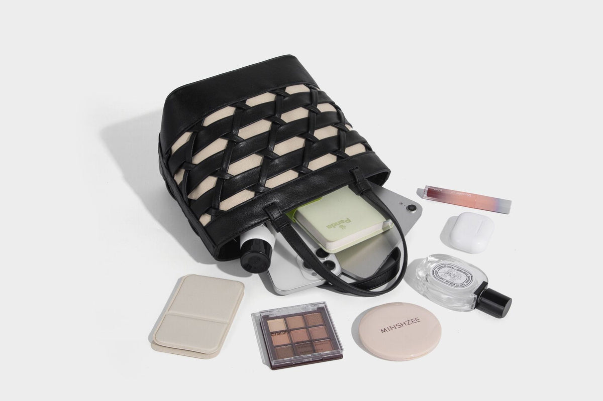 Structured woven lattice tote bag with cream lining, dual top handles, detachable crossbody strap, and silver-tone hardware