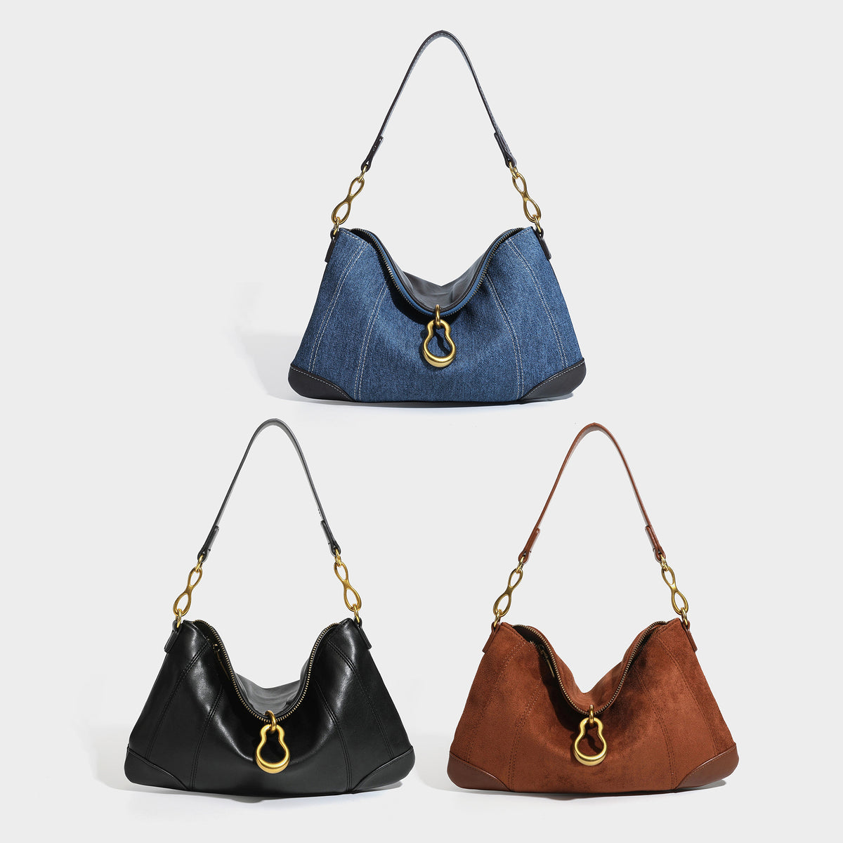 Slouchy denim shoulder bag with dark leather-look trim, gold-tone chain-link hardware, and top zipper closure, detail view 2