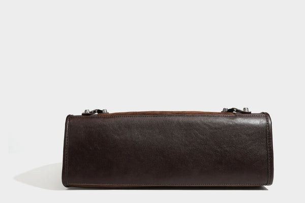Large structured tote bag with matte suede-like body, smooth leather-look trim, front zip pocket, stud hardware, and