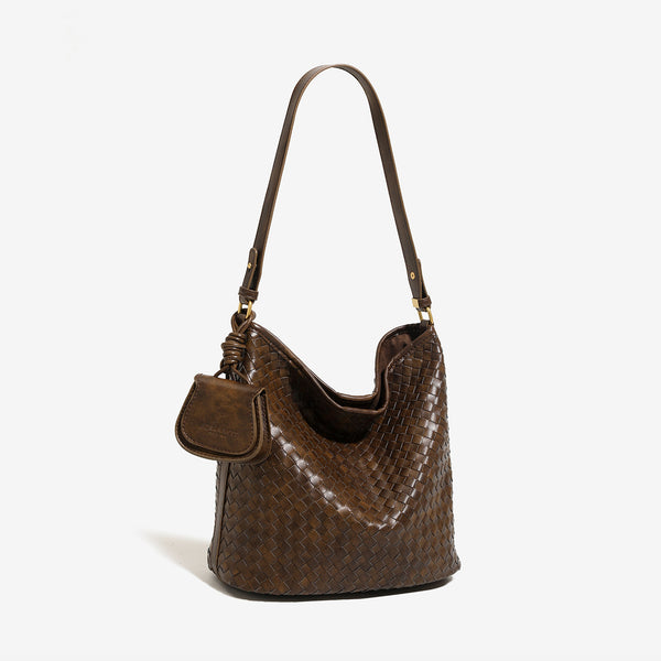Dark brown woven leather-look bucket shoulder bag with mini pouch charm and gold-tone hardware, detail view 2