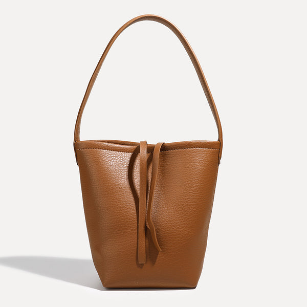 Mini tapered bucket bag in pebbled leather-look finish with front tie straps and single shoulder strap, detail view 10