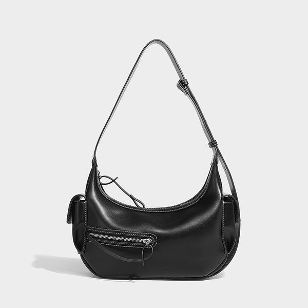 Smooth leather-look crescent shoulder bag with front zip pocket, side flap pockets, adjustable strap, and silver-tone, detail