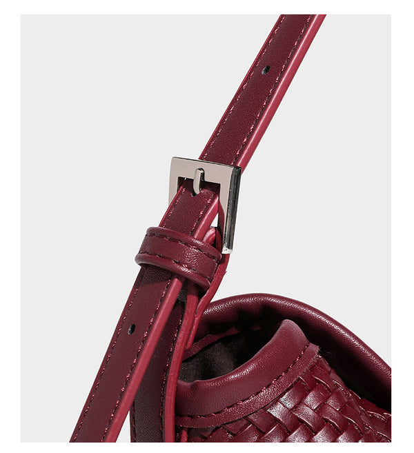 Small woven-look leather-look flap shoulder hobo bag in burgundy with silver-tone hardware and decorative tassel charm