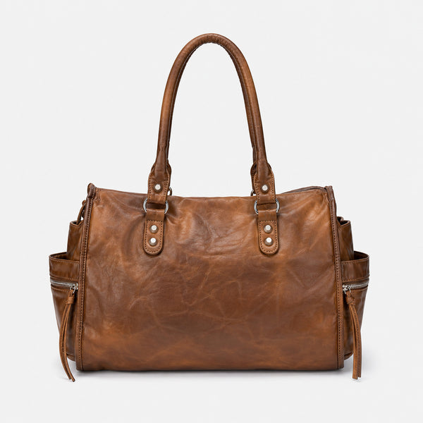 Large distressed leather-look moto tote bag with silver rivets, tassel zip pulls, front zip pocket, and dual top handles