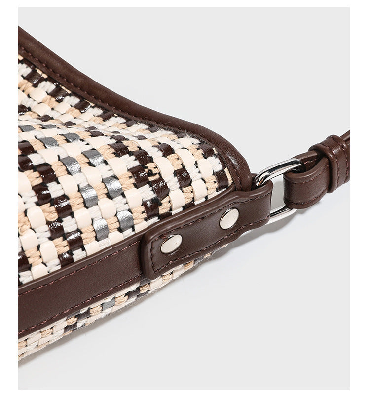 Woven stripe bucket shoulder bag in cream and dark brown with leather-look trim, knotted adjustable strap, and small shield