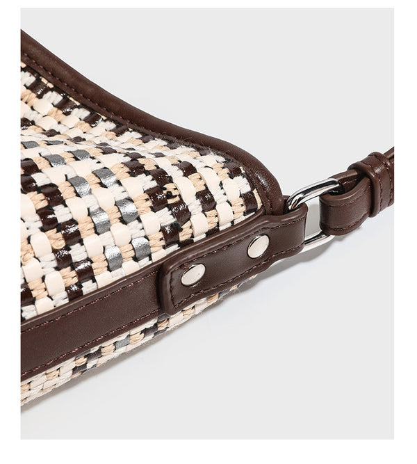 Woven stripe bucket shoulder bag in cream and dark brown with leather-look trim, knotted adjustable strap, and small shield