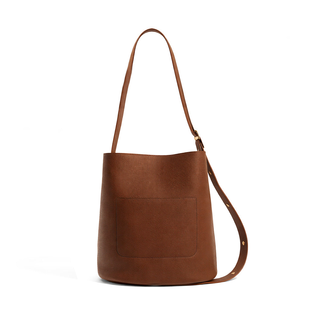 Pebbled textured bucket bag with gold-tone kiss-lock front pocket and adjustable single shoulder strap, detail view 16