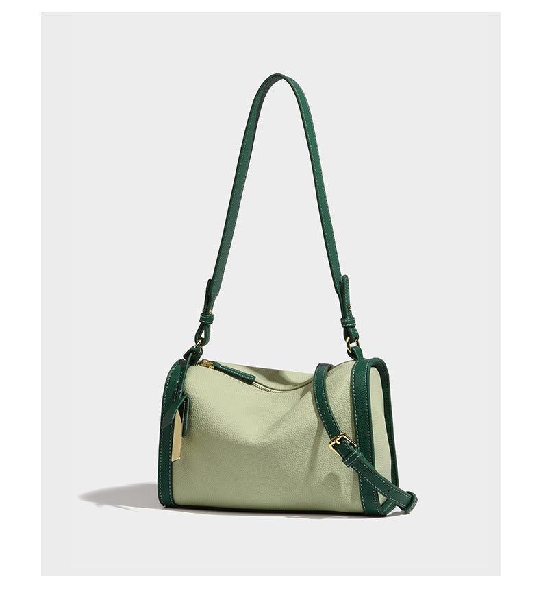 Structured two-tone shoulder bag with pebbled leather-look finish, contrast trim, top zip closure, and gold-tone hardware