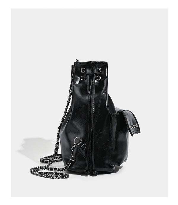 Glossy leather-look drawstring bucket bag with silver dome studs and chain shoulder strap, detail view 12