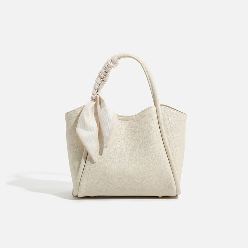 Pebbled leather-look bucket tote bag with scarf-wrapped top handle and gold-tone hardware, detail view 6
