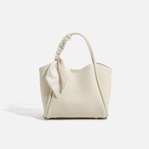 Pebbled leather-look bucket tote bag with scarf-wrapped top handle and gold-tone hardware, detail view 6